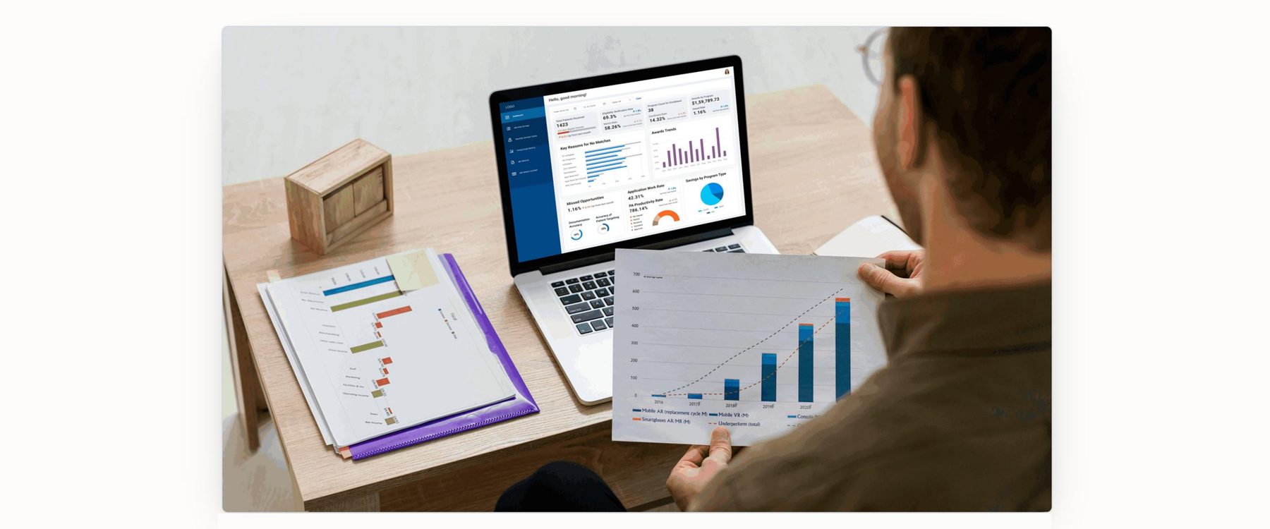 Program manager reviewing dashboard and printed reports